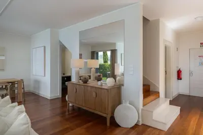 a living room with a table and a mirror at Vila Venusta by An Island Apart in Calheta