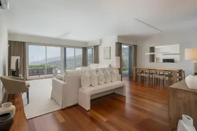 a living room with a white couch and a table at Vila Venusta by An Island Apart in Calheta