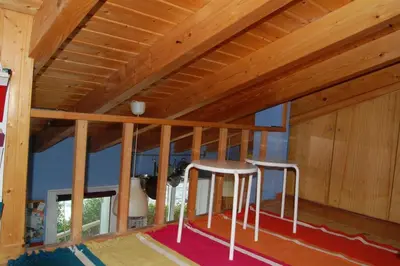 two white stools in a room with wooden ceilings at Arrifana - CASA DAS MARÉS - Casa na Praia in Aljezur