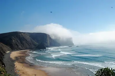 a view of a beach with a mountain at Arrifana - CASA DAS MARÉS - Casa na Praia in Aljezur