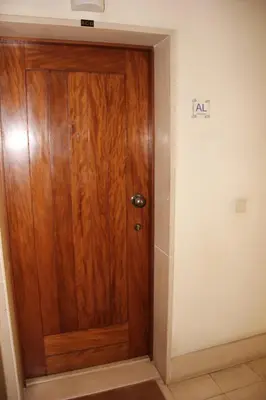 a wooden door in the corner of a room at A Casa da Dúlia in Funchal