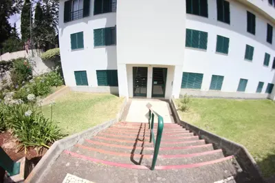 a building with stairs in front of a building at A Casa da Dúlia in Funchal