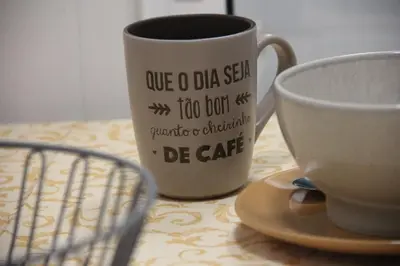 a coffee cup and a saucer on a table at A Casa da Dúlia in Funchal