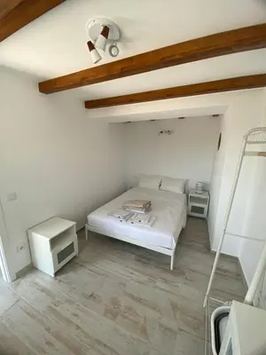 a white bedroom with a bed and two tables at Sunny Aljezur da Misericórdia, Aljezur, Costa Vicentina in Aljezur