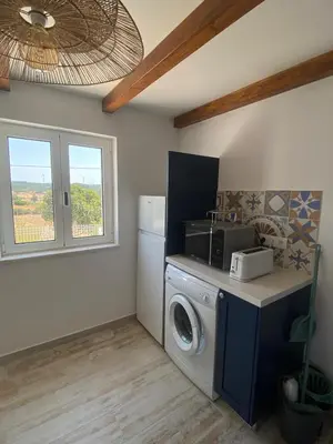 a laundry room with a washing machine and a window at Sunny Aljezur da Misericórdia, Aljezur, Costa Vicentina in Aljezur