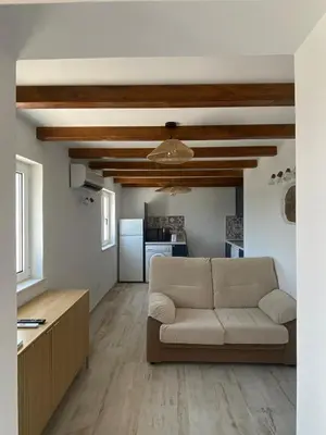 a living room with a couch and a kitchen at Sunny Aljezur da Misericórdia, Aljezur, Costa Vicentina in Aljezur