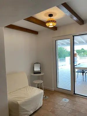 a living room with a bed and a table with a tv at Sunny Aljezur da Misericórdia, Aljezur, Costa Vicentina in Aljezur