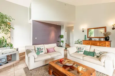 a living room with two couches and a coffee table at Casa do Jardim Botanico in Faial