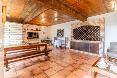 a living room with a wooden bench and a fireplace at Casa do Jardim Botanico in Faial