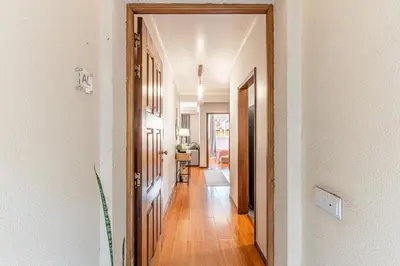 a hallway with a door leading to a living room at Cozy Stay in Caniço