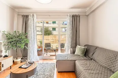 a living room with a couch and a table at Cozy Stay in Caniço
