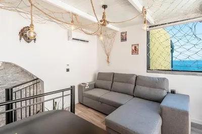 a living room with a couch and a window at Yellow Wave in Paul do Mar