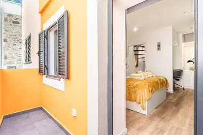a bedroom with a bed and a window at Yellow Wave in Paul do Mar