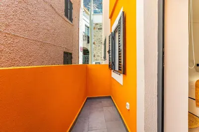 a hallway in a building with orange walls at Yellow Wave in Paul do Mar