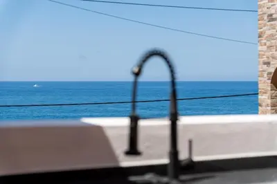 a kitchen sink with a view of the ocean at Yellow Wave in Paul do Mar