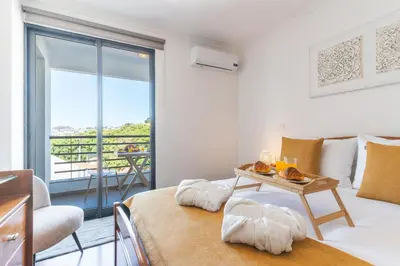 a room with a bed and a table with a view at Pena View Apartment by Atlantic Holiday in Funchal