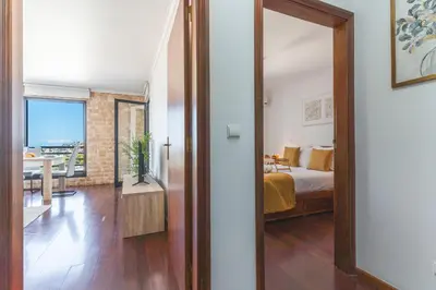 a room with a bedroom with a bed and a mirror at Pena View Apartment by Atlantic Holiday in Funchal