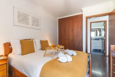 a bedroom with a bed and a table with towels at Pena View Apartment by Atlantic Holiday in Funchal