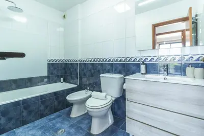 a bathroom with a toilet and a tub and a sink at Pena View Apartment by Atlantic Holiday in Funchal