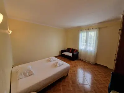 a bedroom with a bed and a chair and a window at Pico Ferreira by MTH in Tábua