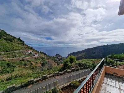 a view from the balcony of a house with the ocean in the background at Pico Ferreira by MTH in Tábua