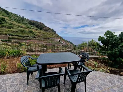 a table and chairs on a patio with a view at Pico Ferreira by MTH in Tábua
