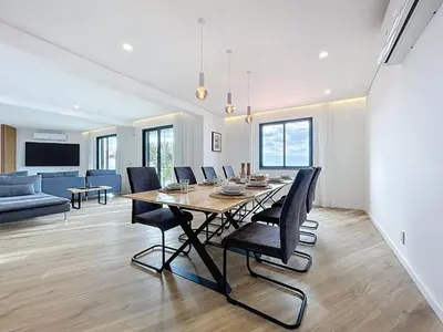 a dining room with a long table and chairs at Breeze House 1 by Atlantic Holiday in Caniço