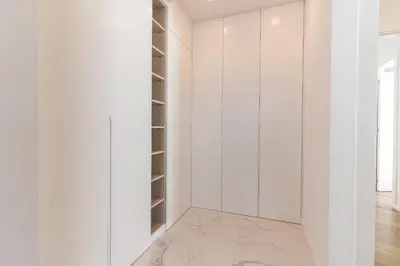 a walk in closet with white walls and a marble floor at Breeze House 1 by Atlantic Holiday in Caniço