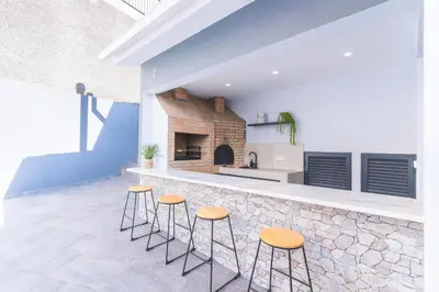 a kitchen with stools in front of a counter at Breeze House 1 by Atlantic Holiday in Caniço