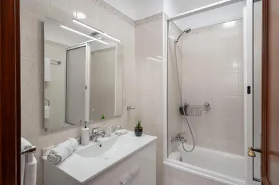 a white bathroom with a sink and a shower at Palmasol by An Island Apart in Calheta