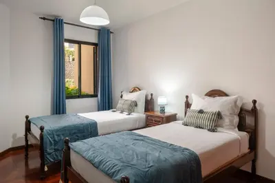 a bedroom with two beds and a window at Palmasol by An Island Apart in Calheta