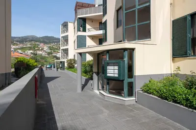 an empty sidewalk next to a building at Palmasol by An Island Apart in Calheta