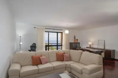 a living room with a couch and a dining room at Palmasol by An Island Apart in Calheta
