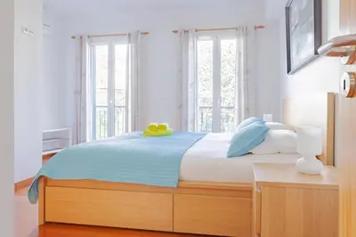 a bedroom with a large bed with two apples on it at Capuchinhas Apartment in Funchal