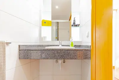 a bathroom with a sink and a mirror at Capuchinhas Apartment in Funchal