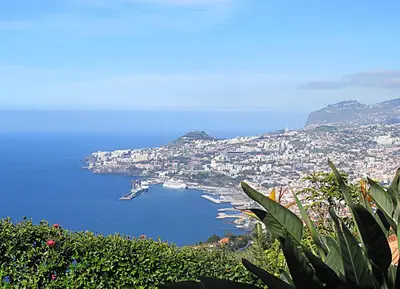 a view of a city and a bay with boats at Capuchinhas Apartment in Funchal