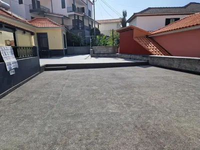 a parking lot in front of some buildings at Machico Villas Accommodation with Private Parking in Machico