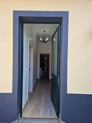 a hallway with a blue door and a hallway with a hallway at Machico Villas Accommodation with Private Parking in Machico