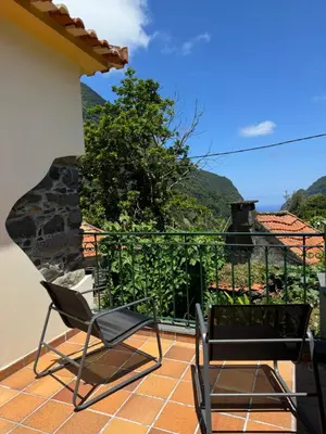 a pair of chairs on a balcony with a view at Boaventura Cottage-Casa de Campo in Serra de Água