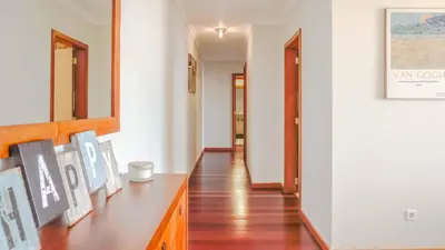 a bedroom with a bed with a lamp and a window at Like Home VI Praia Formosa I Sea View Balcony I Free Parking in Funchal