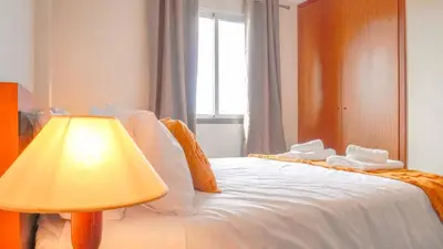 a living room with a couch and a television at Like Home VI Praia Formosa I Sea View Balcony I Free Parking in Funchal