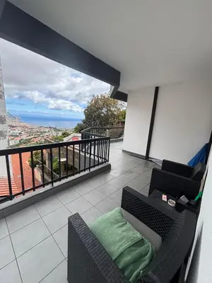 a balcony with a couch and a view of the ocean at Casa Barcelos in Funchal