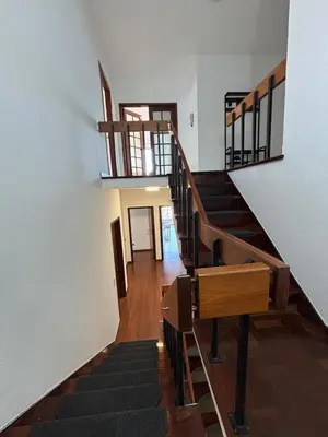 a staircase in a house with wooden floors and white walls at Casa Barcelos in Funchal