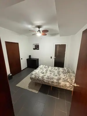 a bedroom with a bed and a ceiling fan at Casa Barcelos in Funchal