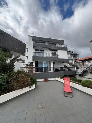 a red chair sitting in front of a building at Casa Barcelos in Funchal