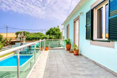 a balcony of a house with a swimming pool at Casa da Tia Celeste I, a Home in Madeira in Ponta do Sol