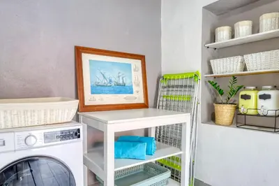a laundry room with a washer and dryer at Casa da Tia Celeste I, a Home in Madeira in Ponta do Sol