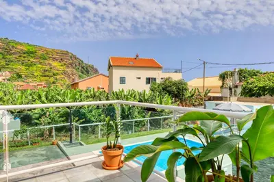 a view from the balcony of a house with a swimming pool at Casa da Tia Celeste I, a Home in Madeira in Ponta do Sol