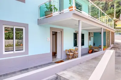 a blue house with a balcony and a patio at Casa da Tia Celeste II, a Home in Madeira in Ponta do Sol