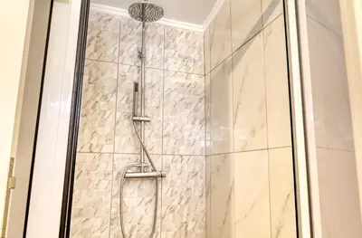 a shower with a glass door in a bathroom at Casa da Tia Celeste II, a Home in Madeira in Ponta do Sol